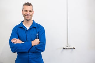 Mechanic smiling at the camera at the repair garage