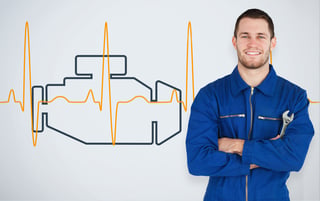 Portrait of a smiling young mechanic next to background with car engine and heart line