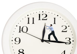 clock hands being pushed back by a business man