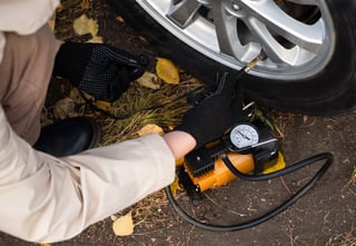 man-driver-hand-inflating-tires-of-vehicle-removi-2024-01-22-19-38-31-utc